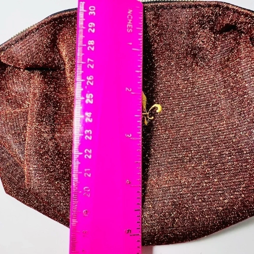 Shiny makeup pouch with fleur de lis symbol